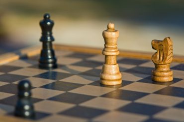 A chessboard with some chess pieces